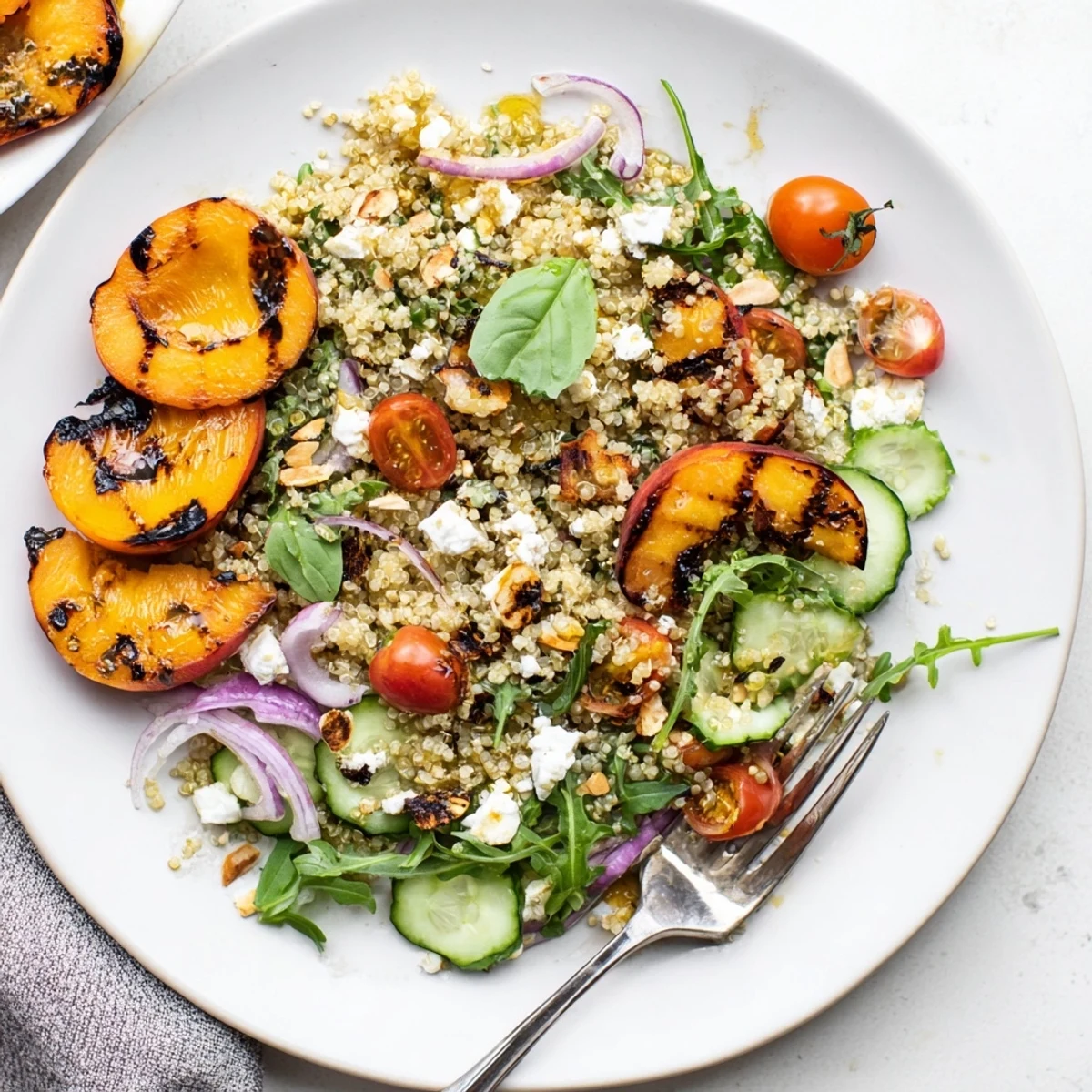 Healthy grilled apricot basil quinoa grain salad featuring charred apricots and crisp vegetables