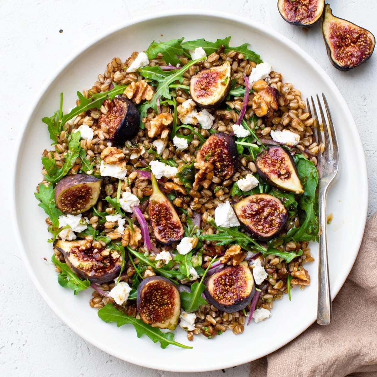 Vibrant Mediterranean farro grain bowl featuring caramelized figs, peppery arugula, and tangy balsamic vinaigrette