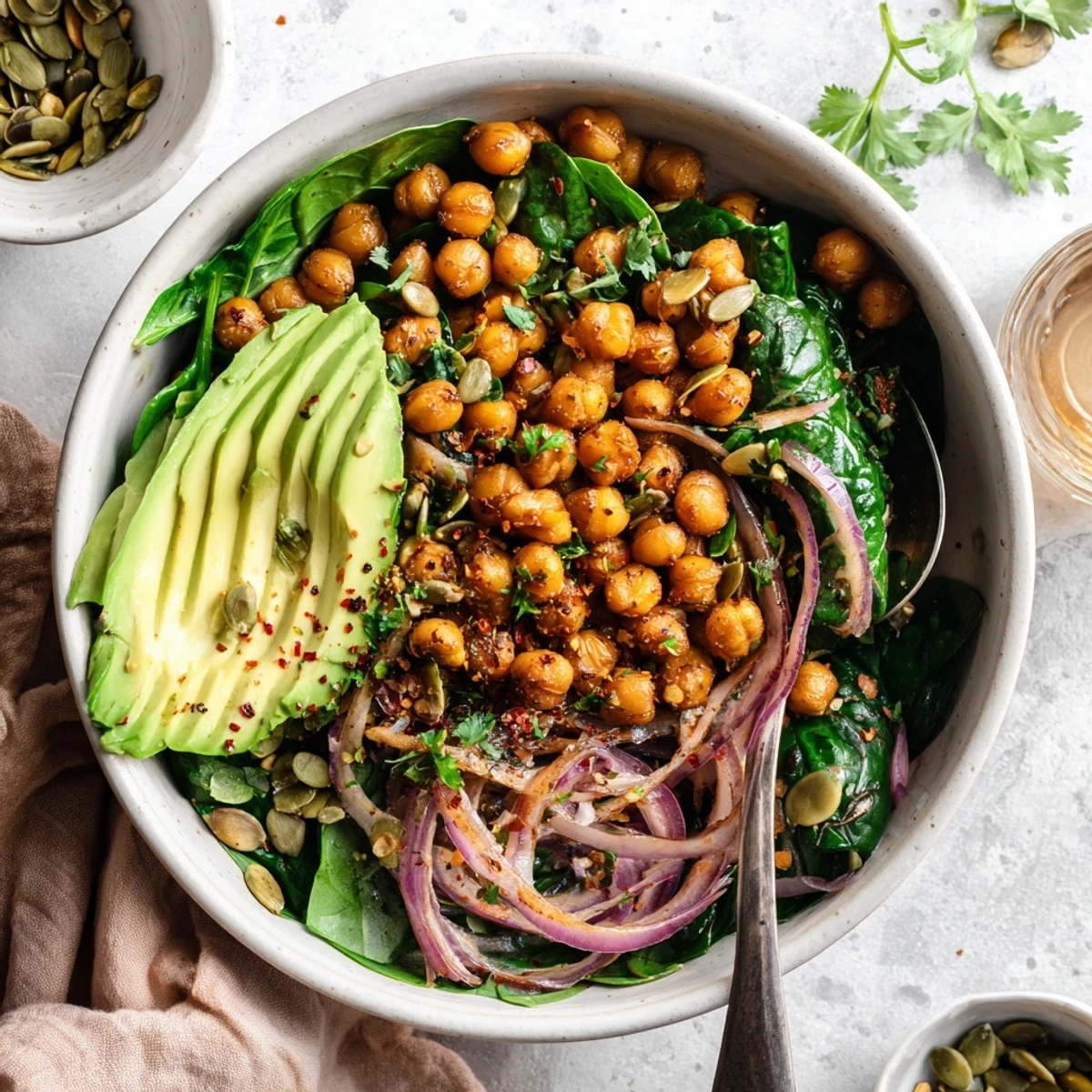 Vibrant Mediterranean breakfast bowl featuring spiced chickpeas, fresh spinach, and bright lemon garlic flavors