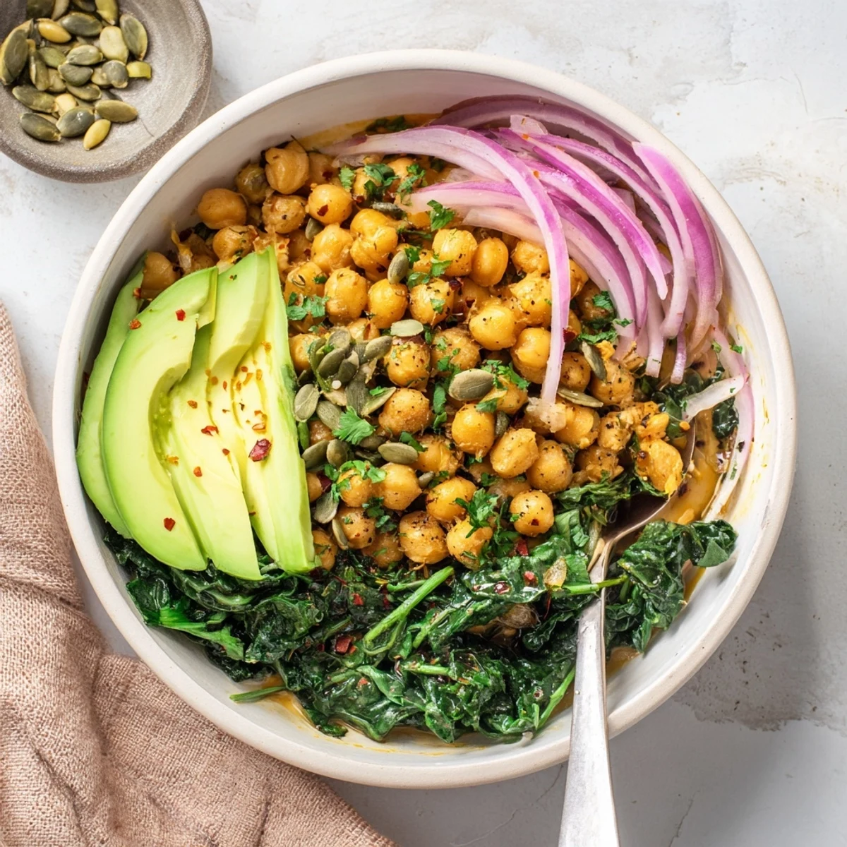 Protein-packed savory breakfast bowl with chickpeas, spinach, red onion, and zesty lemon garlic seasoning