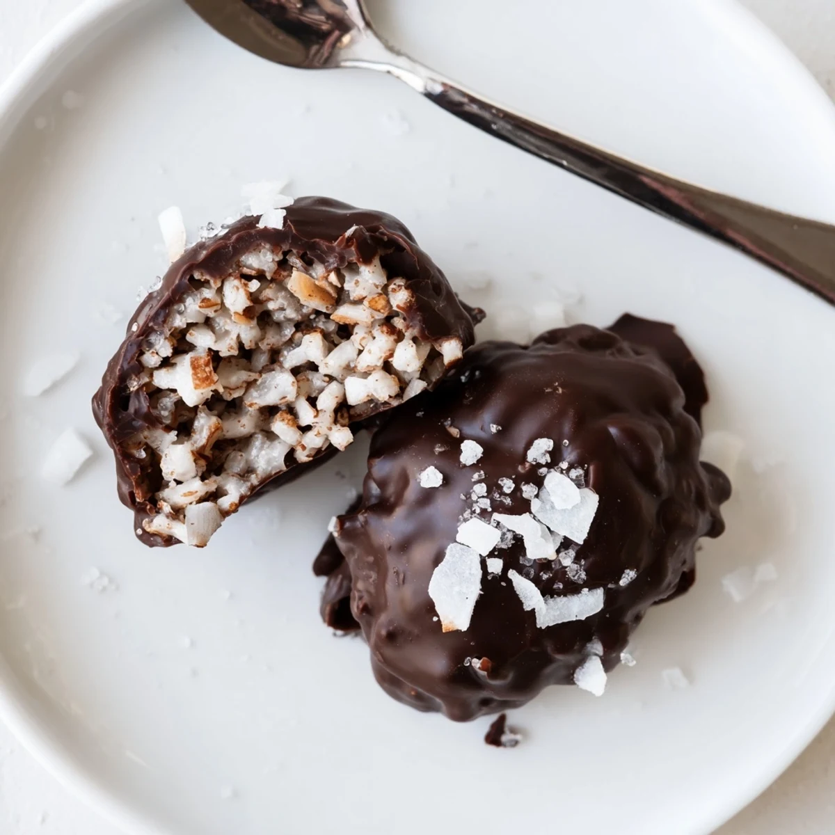 Chilled on parchment, Dark Chocolate Almond Butter Coconut Crunch Clusters glisten ready to serve
