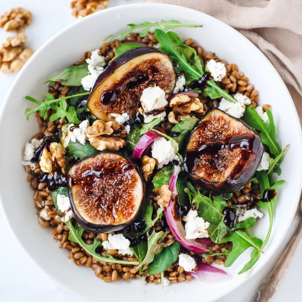 Fork-ready Roasted Fig Balsamic Farro Grain Salad tossed with peppery arugula and walnuts