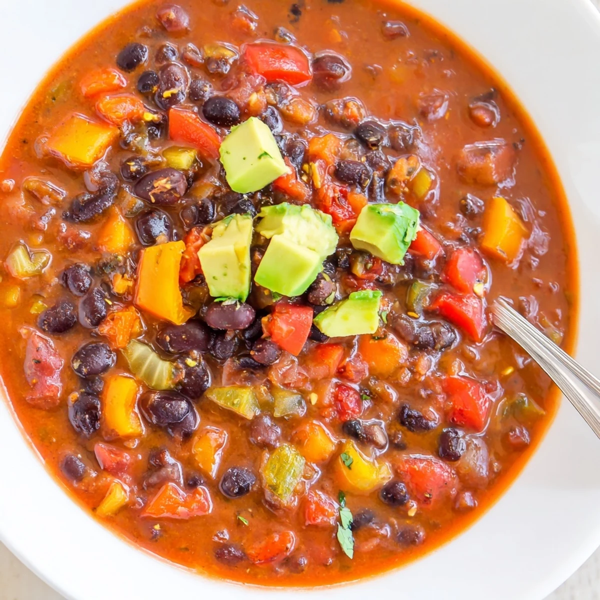 Smoky Black Bean and Roasted Pepper Hearty Soup steaming in bowl, creamy.