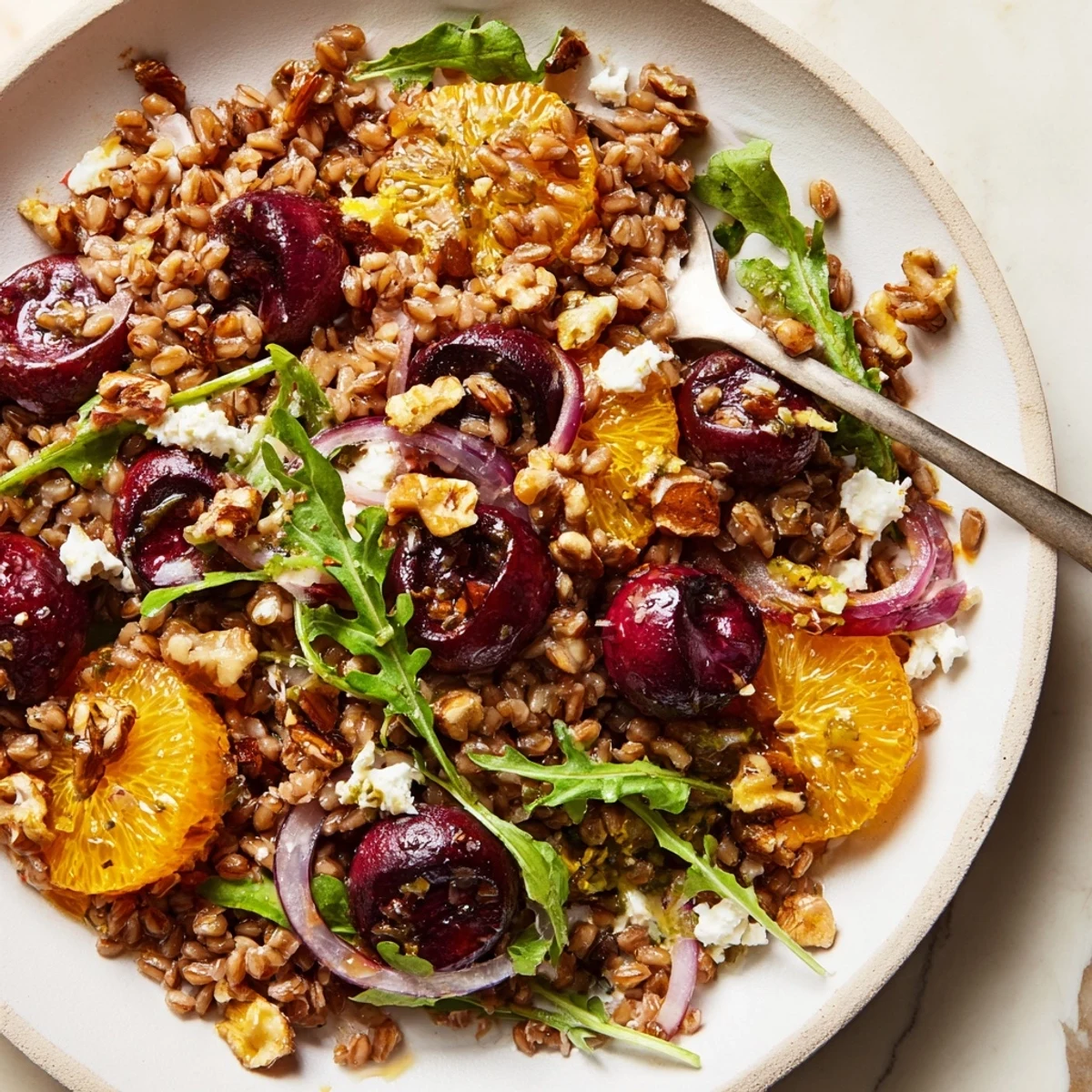 Bright Roasted Cherry Orange Farro Grain Salad tossed in citrus vinaigrette, topped with feta