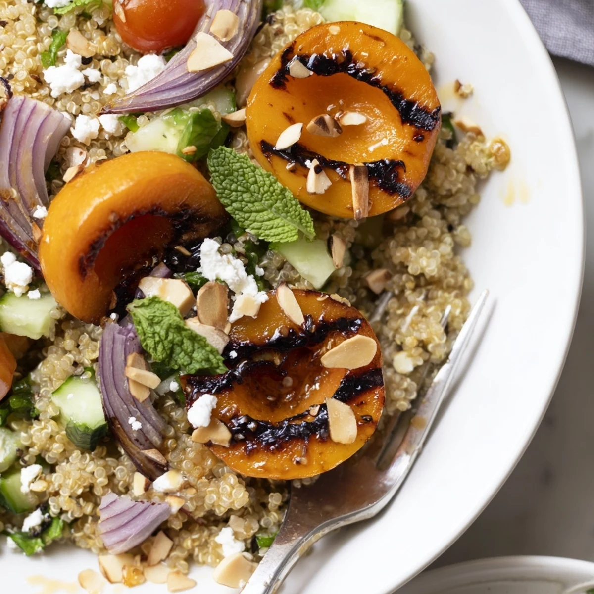 Serve Grilled Apricot Mint Quinoa Grain Salad chilled, juicy apricots and toasted almonds