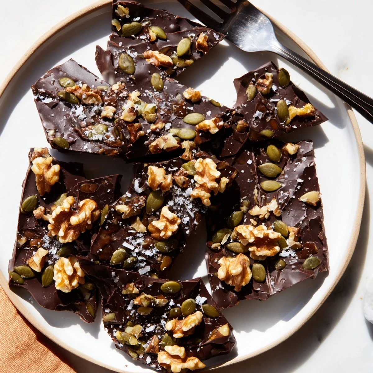Dark chocolate walnut coconut crunch bark broken into rustic shards studded with crunchy walnuts