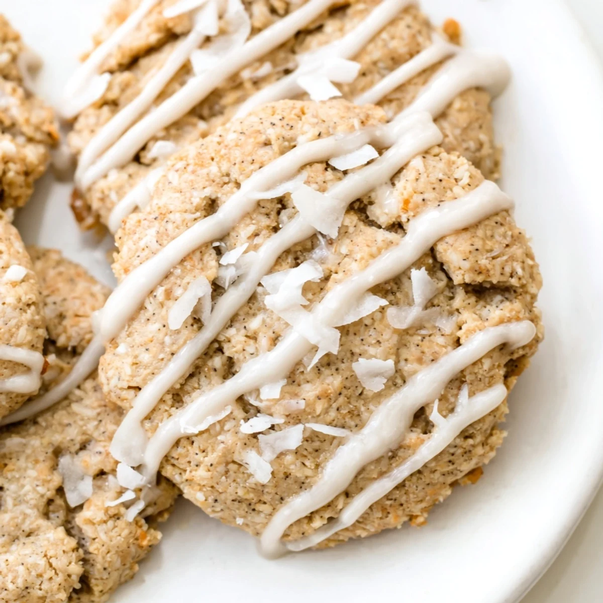 Chewy keto vanilla coconut butter drizzle cookies stacked on a plate for a low-carb dessert