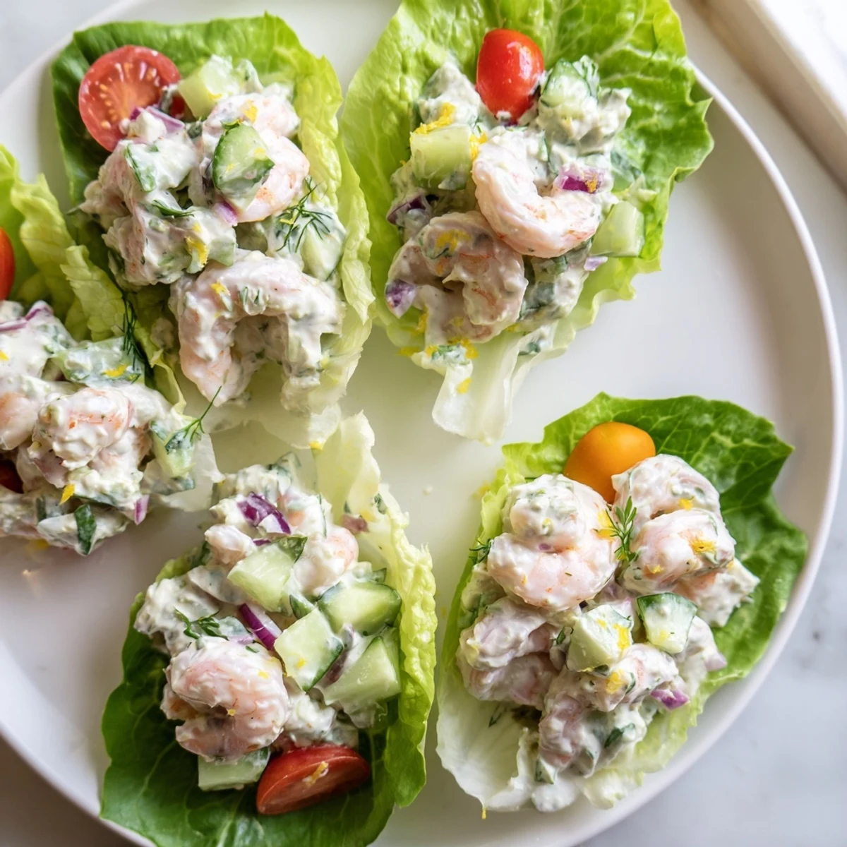 Creamy cottage cheese lemon basil shrimp salad nestled in vibrant green lettuce leaves