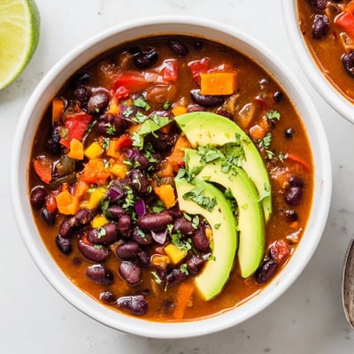 Smoky Black Bean and Roasted Pepper Hearty Soup creamy, smoky aroma, avocado garnish